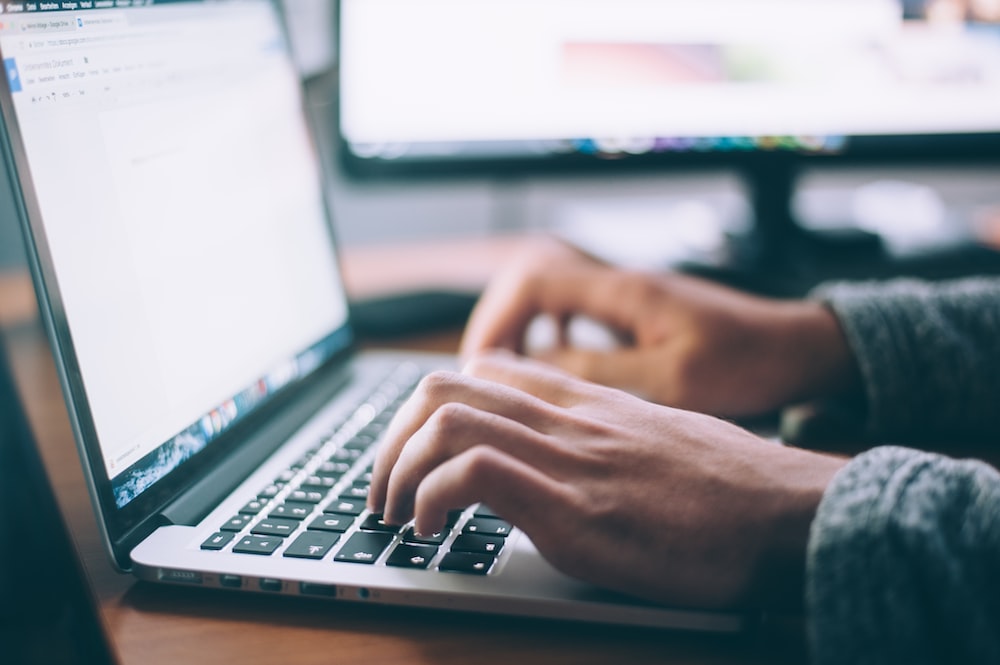 Internet for UPSC study, image shows person on work station using keyboard for online study
