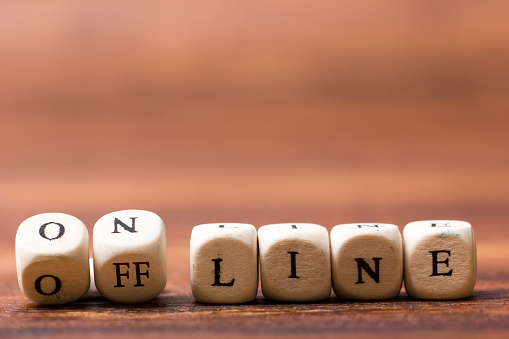 APSC and UPSC Offline guidance program. Image shows wooden blocks with offline , online written on them