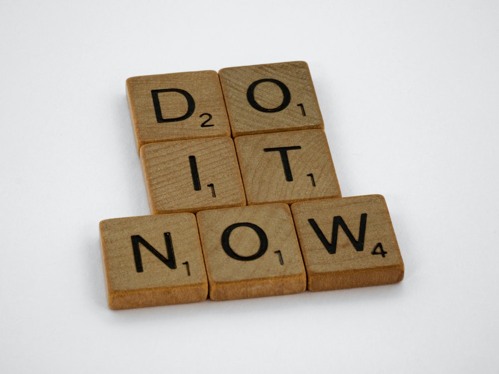 Procrastination in APSC/UPSC. Image shows the words do it now in black over brown cardboard